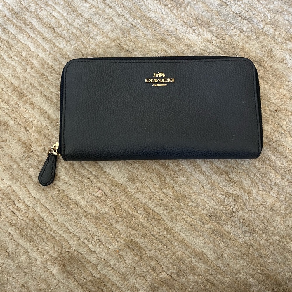 Gently used- black pebble leather Coach wallet. Gold hardware.